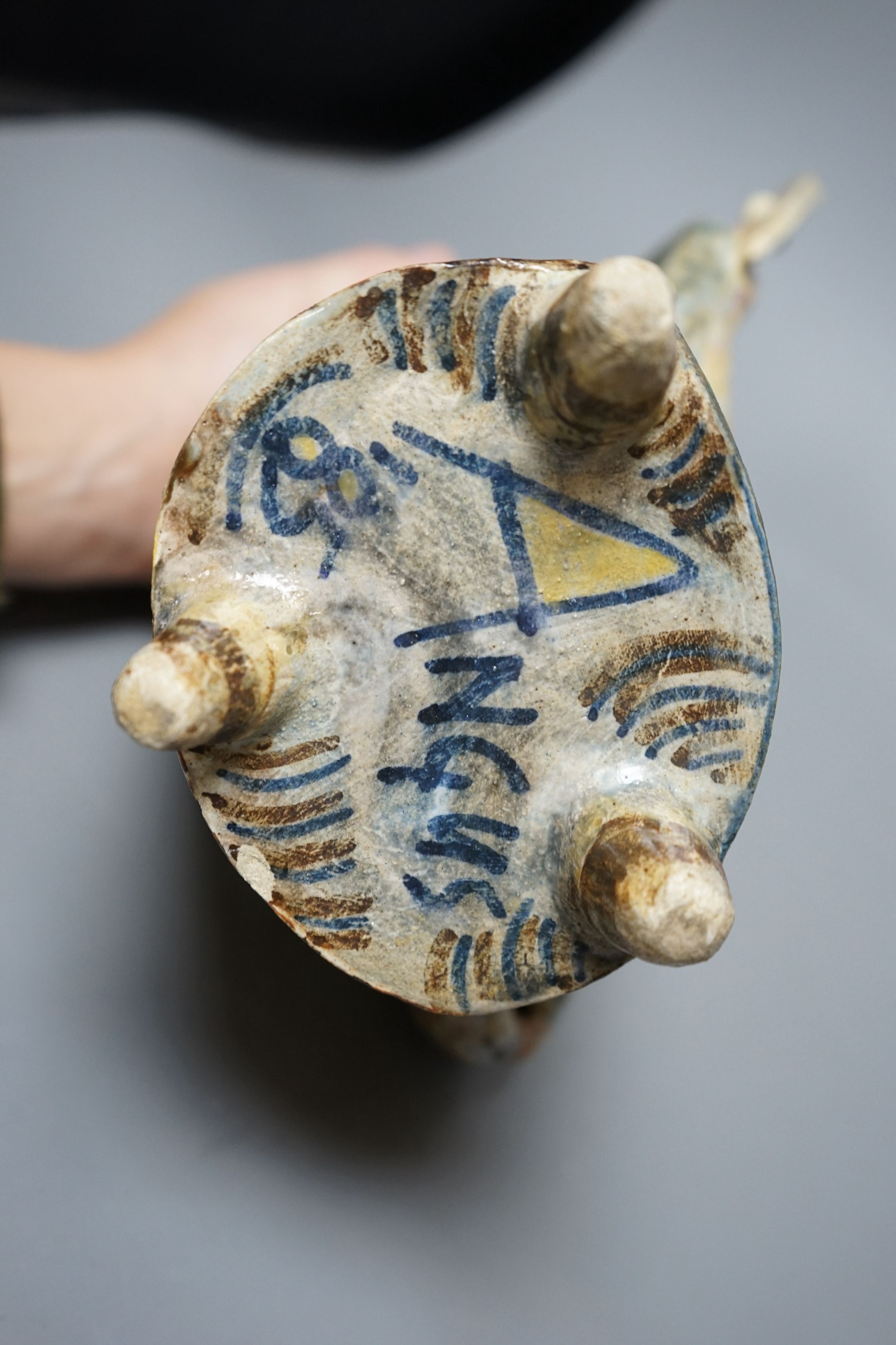 Angus Suttie (1946-1993), an abstract polychrome glazed stoneware jug and cover on tripod base, inscribed ‘Angus 86’, 29cm tall (Damage)